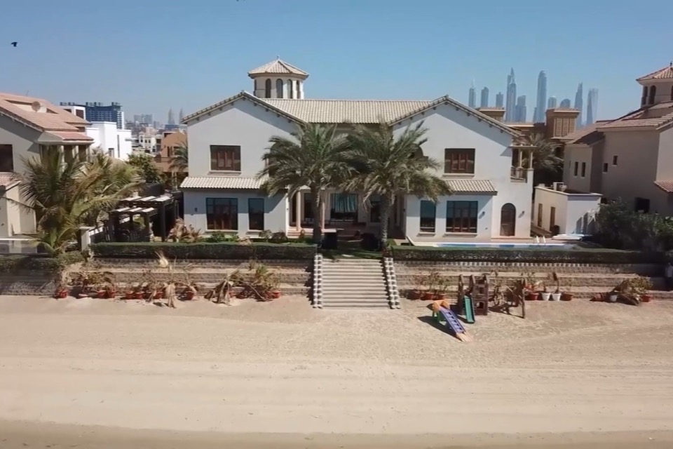 A villa on the beach in Dubai with the skyline in the distance